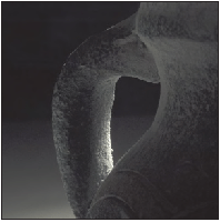 A telephoto perspective and a creative use of light make this photo of part of a jug interesting